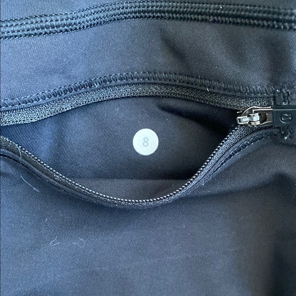 Black, cropped Lululemon leggings with pockets, ruched bottoms and zipped pocket - Picture 9 of 15